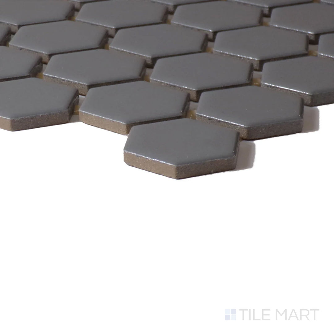 Corner view of Color Wheel Mosaic Suede Gray 1.5" Hexagon Glossy Glazed Ceramic, emphasizing its sophisticated gray tone with a luminous, glossy finish.