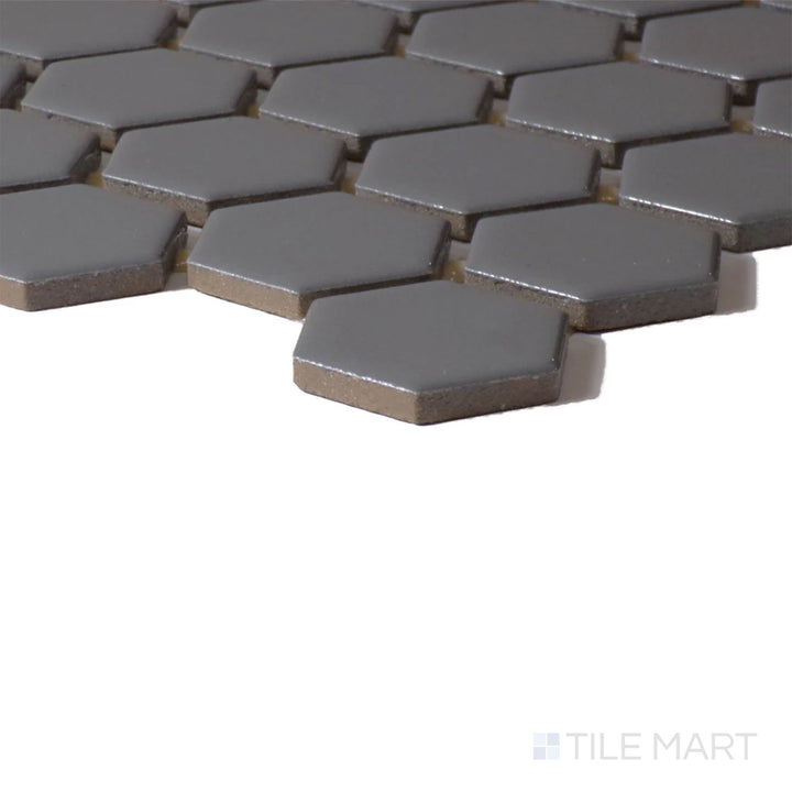 Corner view of Color Wheel Mosaic Suede Gray 1.5" Hexagon Glossy Glazed Ceramic, emphasizing its sophisticated gray tone with a luminous, glossy finish.