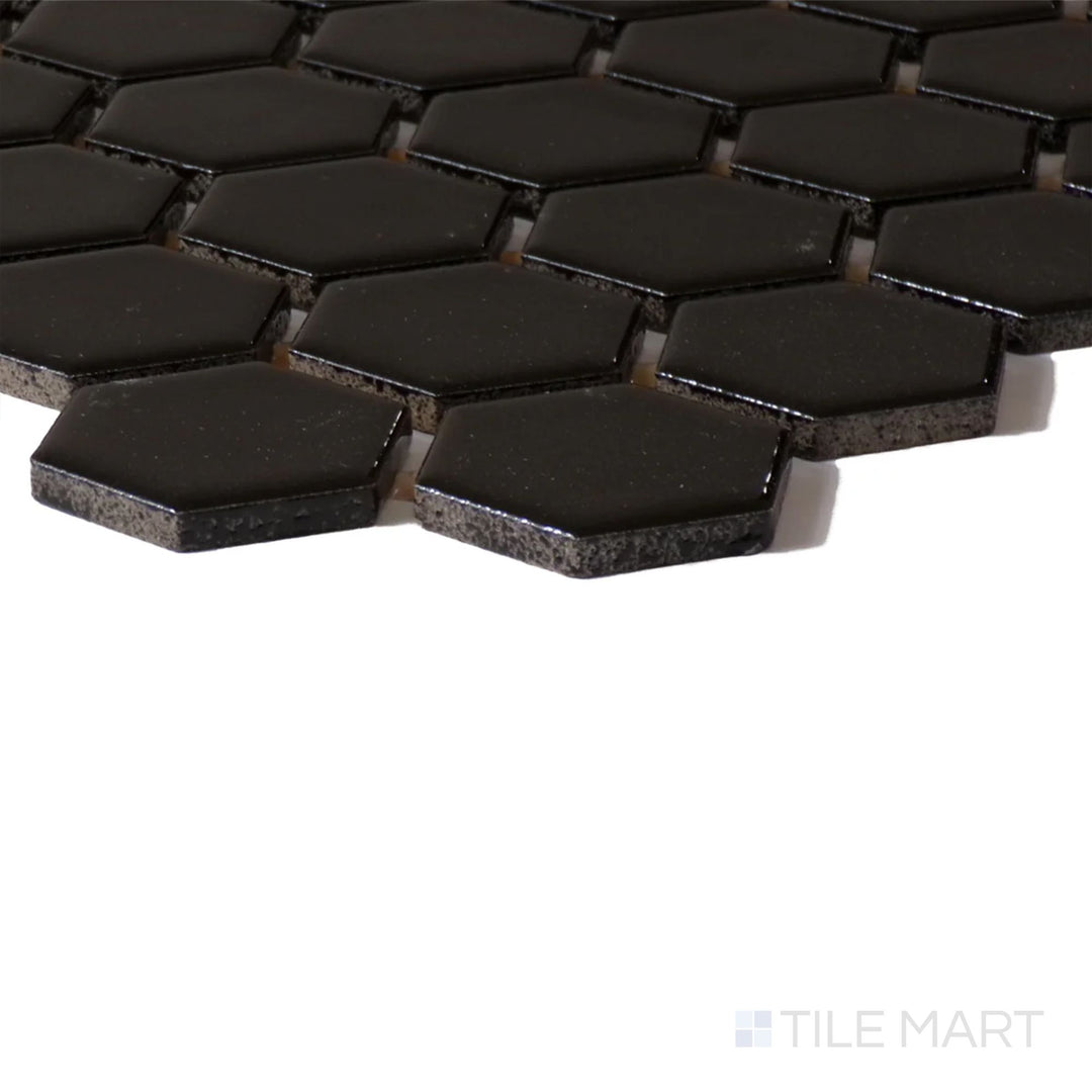 Angled shot of Color Wheel Mosaic Black 1.5" Hexagon Glossy Glazed Ceramic, displaying its rich black color and striking glossy sheen.
