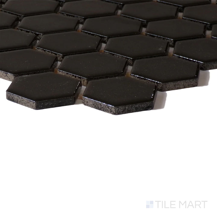 Angled shot of Color Wheel Mosaic Black 1.5" Hexagon Glossy Glazed Ceramic, displaying its rich black color and striking glossy sheen.