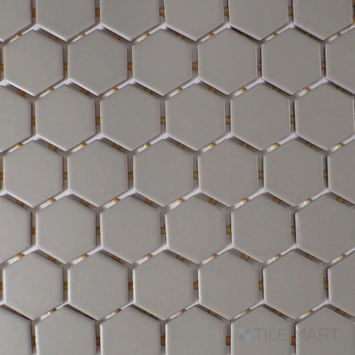 Viewed from the top, the Color Wheel Mosaic Architectural Gray 1.5" hexagon matte glazed ceramic tile presents a modern gray hue with a smooth, non-reflective surface, perfect for creating subtle texture in interiors.