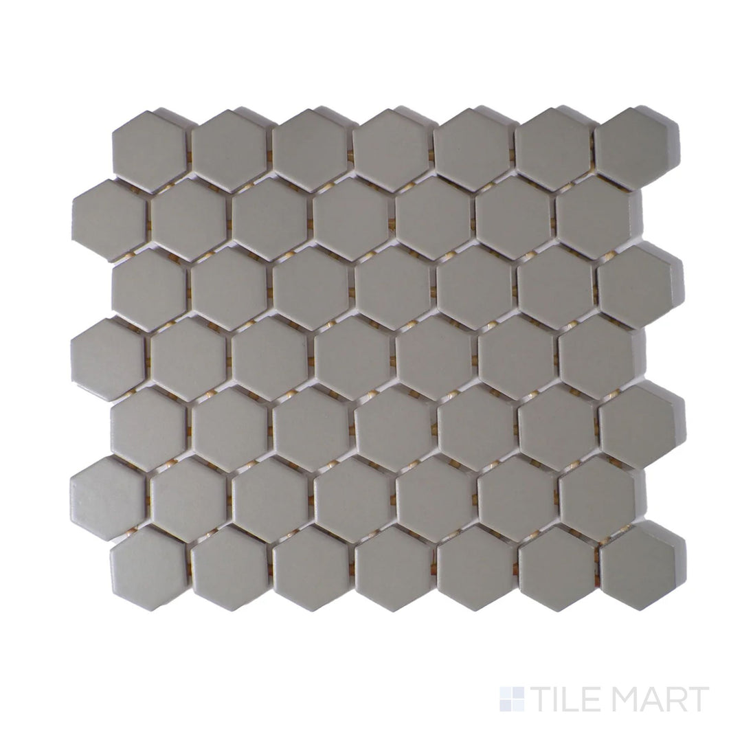Angled shot of Color Wheel Mosaic Architectural Gray 1.5" hexagon matte glazed ceramic tile, showcasing a sophisticated gray hue with a velvety matte surface in a modern hexagonal pattern.  