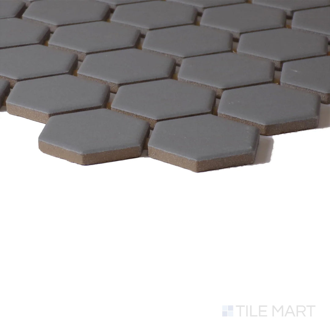 Corner view of Color Wheel Mosaic Suede Gray 1.5" Hexagon Matte Glazed Ceramic, emphasizing its subtle gray color and soft matte appearance.