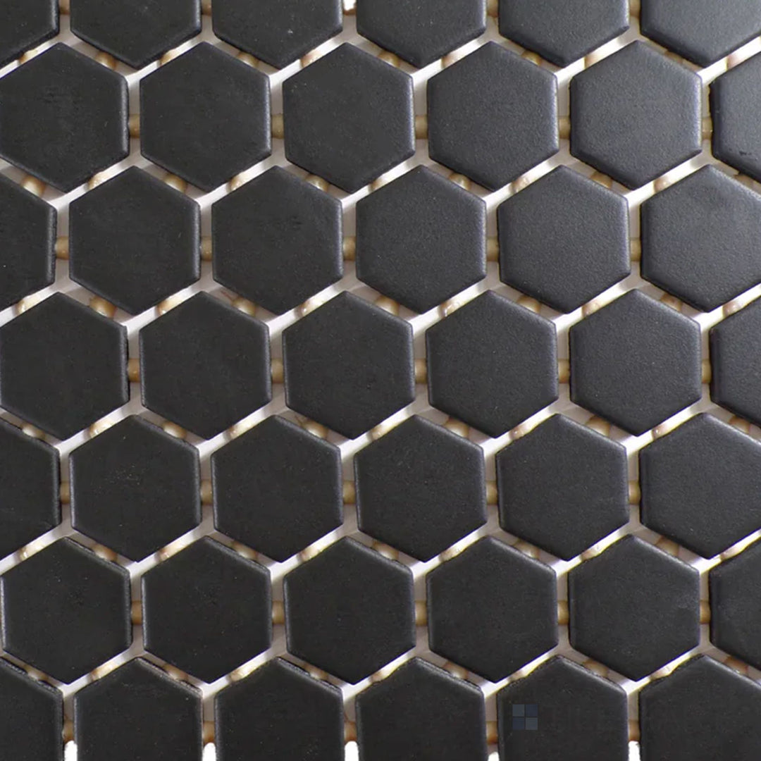 Viewed from the top, the Color Wheel Mosaic Black 1.5" hexagon matte glazed ceramic tile displays a bold black shade with a smooth, matte surface, delivering a sophisticated, understated look.