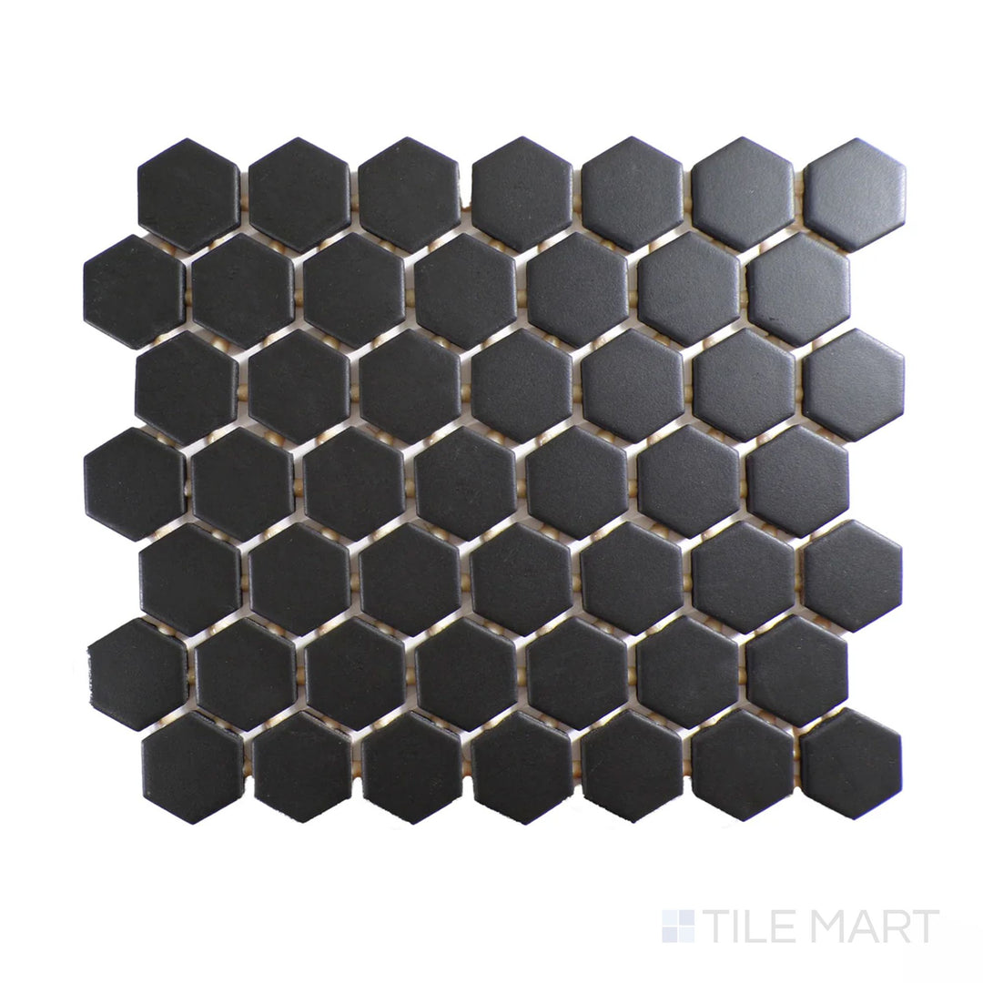 Diagonal view of Color Wheel Mosaic Black 1.5" hexagon matte glazed ceramic tile, featuring a rich black hue with a matte surface in a bold hexagonal layout.  
