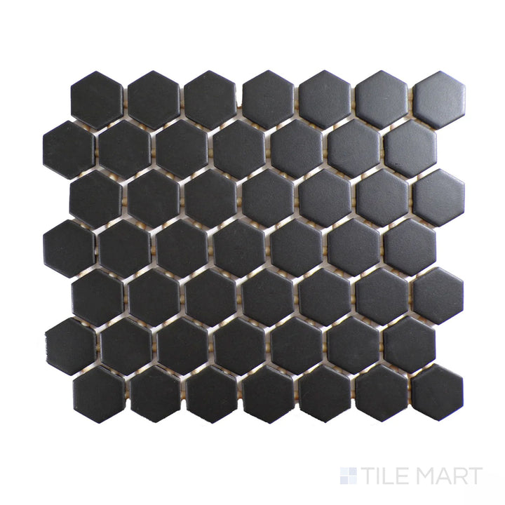 Diagonal view of Color Wheel Mosaic Black 1.5" hexagon matte glazed ceramic tile, featuring a rich black hue with a matte surface in a bold hexagonal layout.  