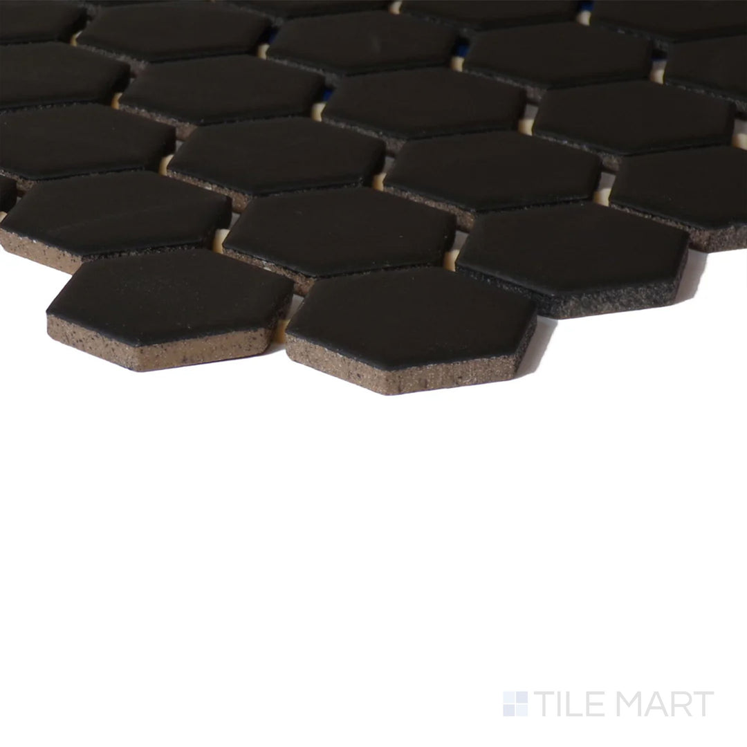 Angled shot of Color Wheel Mosaic Black 1.5" Hexagon Matte Glazed Ceramic, displaying its rich black tone with a smooth, muted matte glaze.