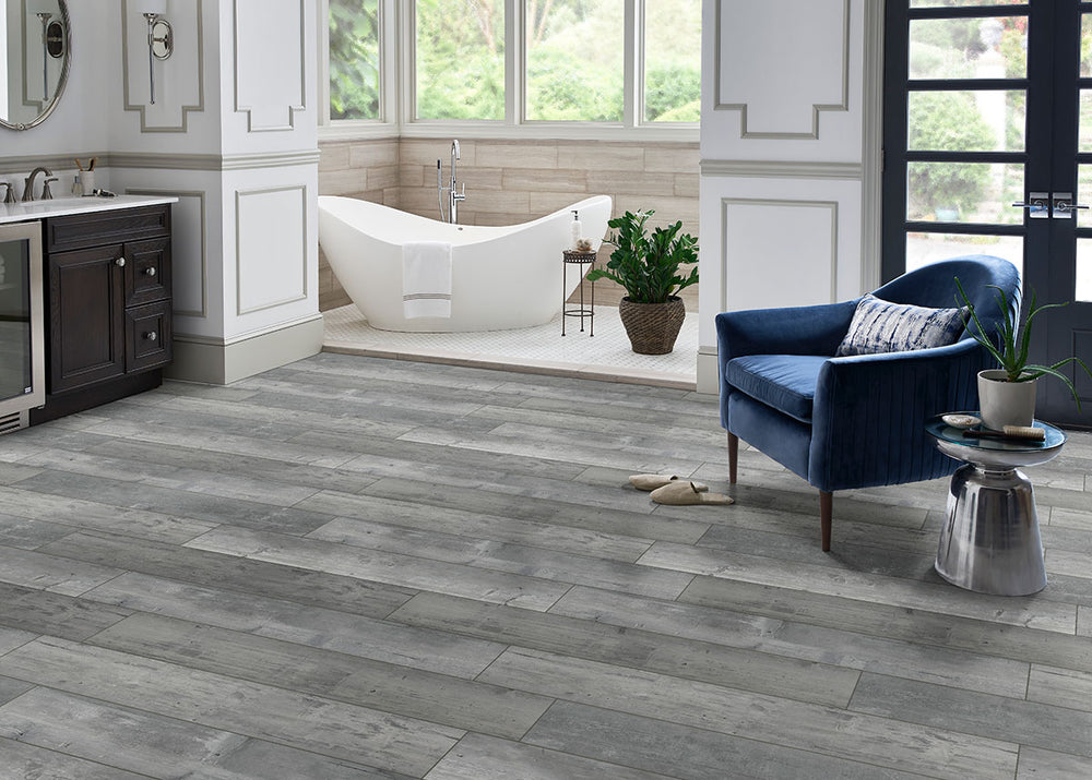 Bringing focus to the sophisticated look of ANDOVER KINGSDOWN GRAY 7x48 VINYL TILE with a LOW GLOSS finish, adding a touch of warmth and texture to the space.