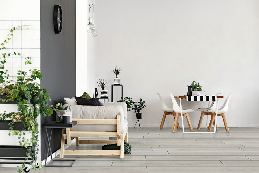 Light and airy wood-look planks brighten the space, adding a fresh and modern feel with Andover Whitby White 7x48 low gloss luxury plank vinyl.