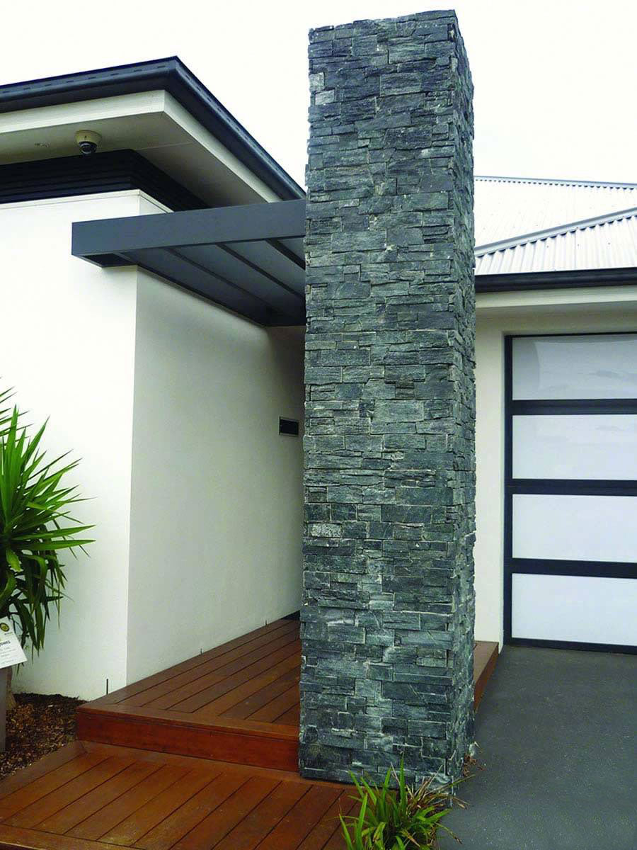 A bold and earthy aesthetic with Rockmount Coal Canyon 6X24 Stacked Stone Panel Splitface Quartzite, showcasing deep charcoal tones and rugged stone texture.