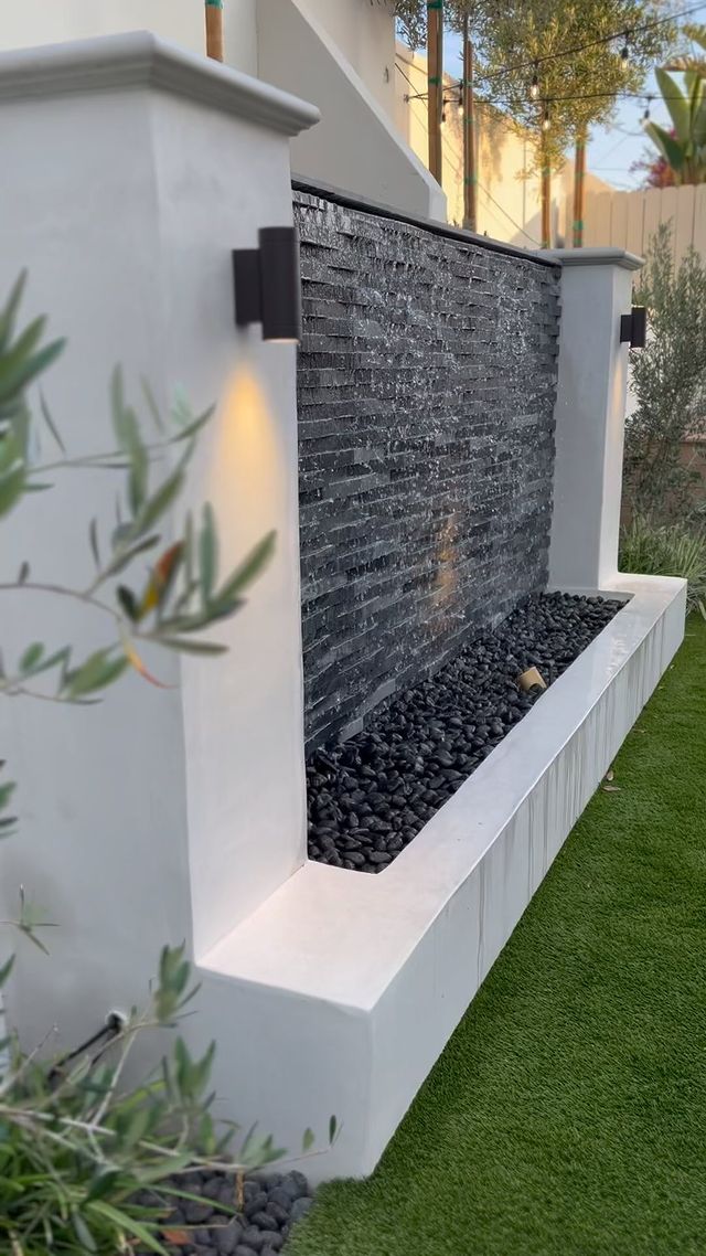 A deep black honed marble panel with subtle veining adds sophistication and modern contrast, enhancing interiors with Rockmount Cosmic Black 6x24 stacked stone panel honed marble.