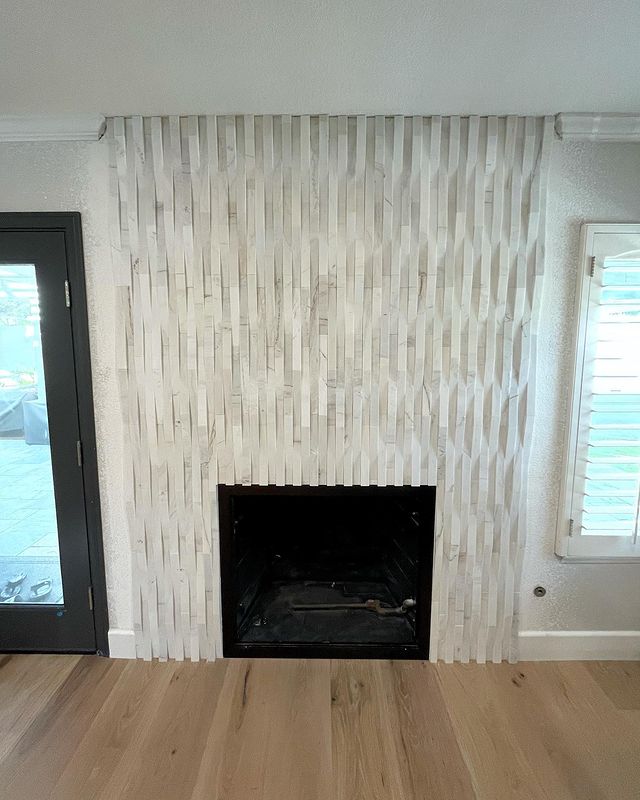 A sleek and contemporary space is elevated with Rockmount Cosmic Gray 6X24 Stacked Stone Panel Honed Marble, offering refined gray hues and a smooth honed finish.