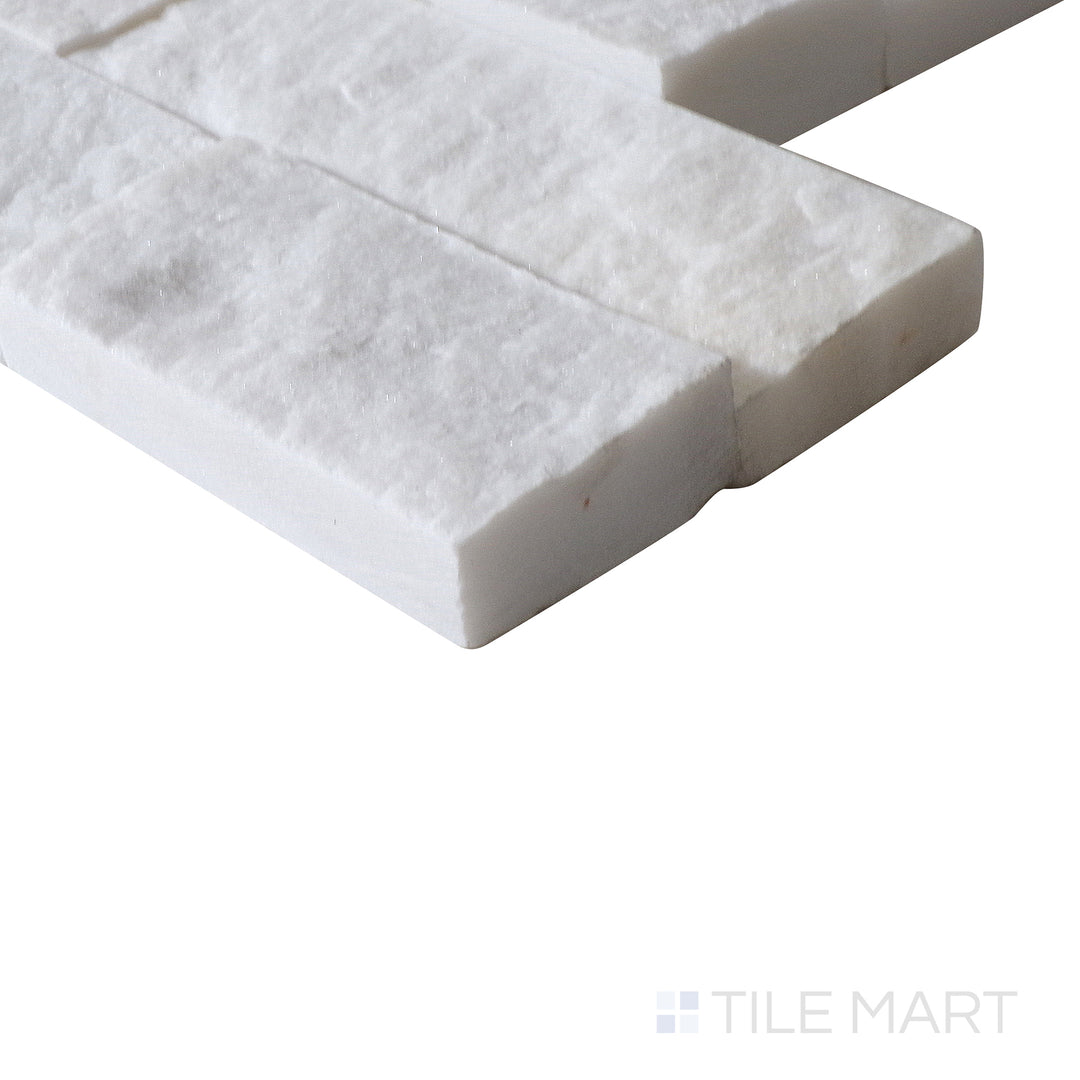 Corner shot of COSMIC WHITE SPLIT FACE 6X24 PANEL MARBLE PANEL with a SPLITFACE finish, emphasizing the layered construction and the product's distinct edge design.