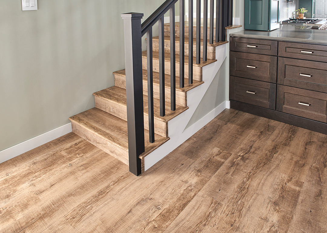 A rich and inviting wood-inspired design, Cyrus Ryder 7X48 Low Gloss Luxury Plank Vinyl blends warm brown hues with authentic grain patterns.