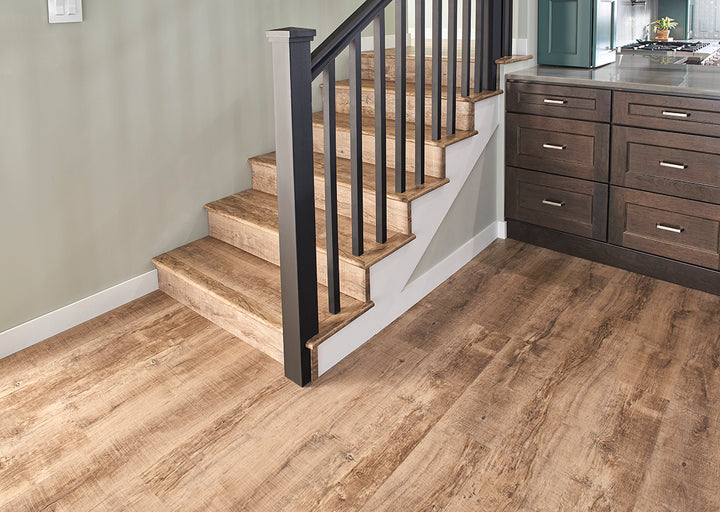 A rich and inviting wood-inspired design, Cyrus Ryder 7X48 Low Gloss Luxury Plank Vinyl blends warm brown hues with authentic grain patterns.