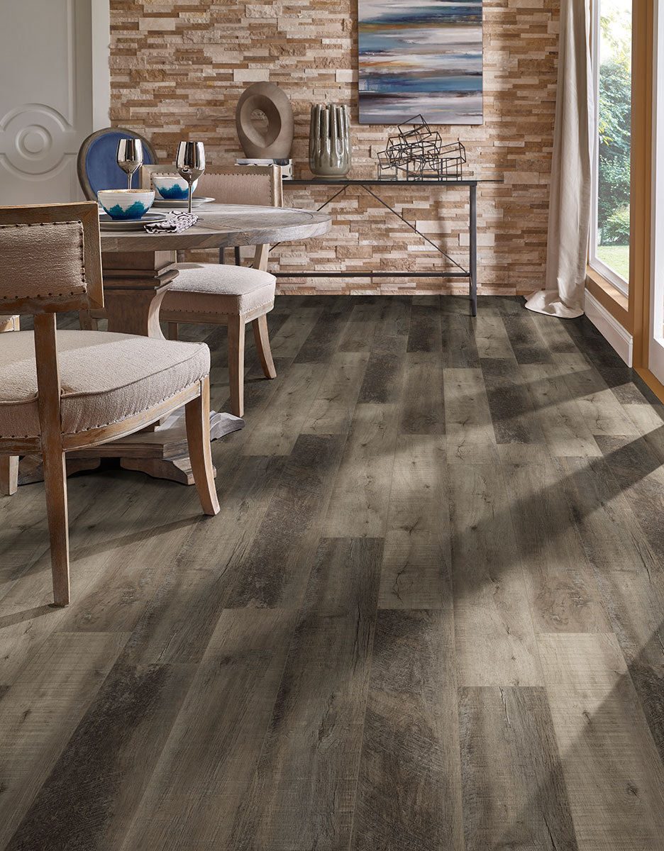 A bold and elegant wood-look design, Cyrus Wolfeboro 7X48 Low Gloss Luxury Plank Vinyl blends dark brown and gray tones with realistic wood textures.