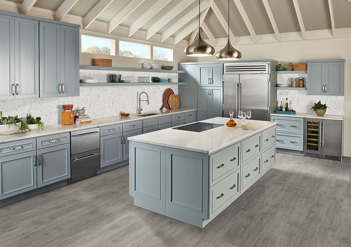 A modern wood-look vinyl plank, Cyrus Grayton 9X60 Low Gloss Luxury Plank Vinyl showcases soft gray tones with authentic wood grain patterns.
