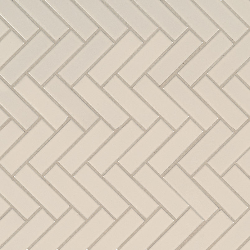 Top-down view of ALMOND GLOSSY HERRINGBONE MOSAIC in PORCELAIN MOSAIC with a GLOSSY finish, revealing the subtle texture and color tones.