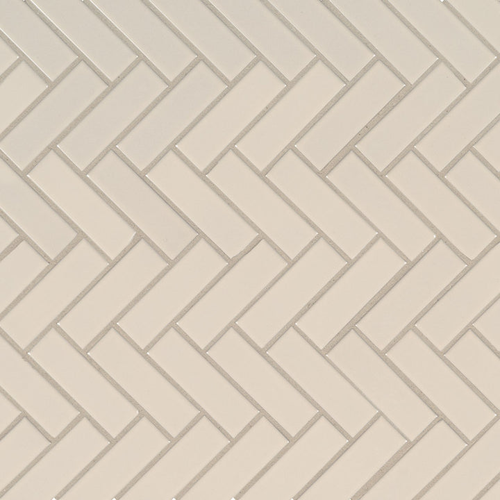 Top-down view of ALMOND GLOSSY HERRINGBONE MOSAIC in PORCELAIN MOSAIC with a GLOSSY finish, revealing the subtle texture and color tones.