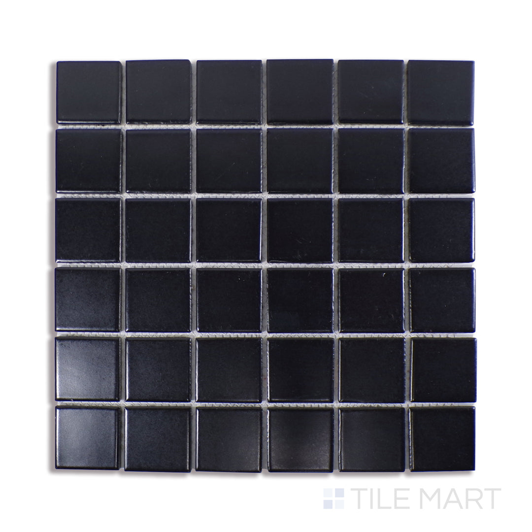 Angled shot of BLACK 2X2 GLOSSY PORCELAIN MOSAIC with a GLOSSY finish, offering a detailed look at the material's finish with a tilted viewpoint.