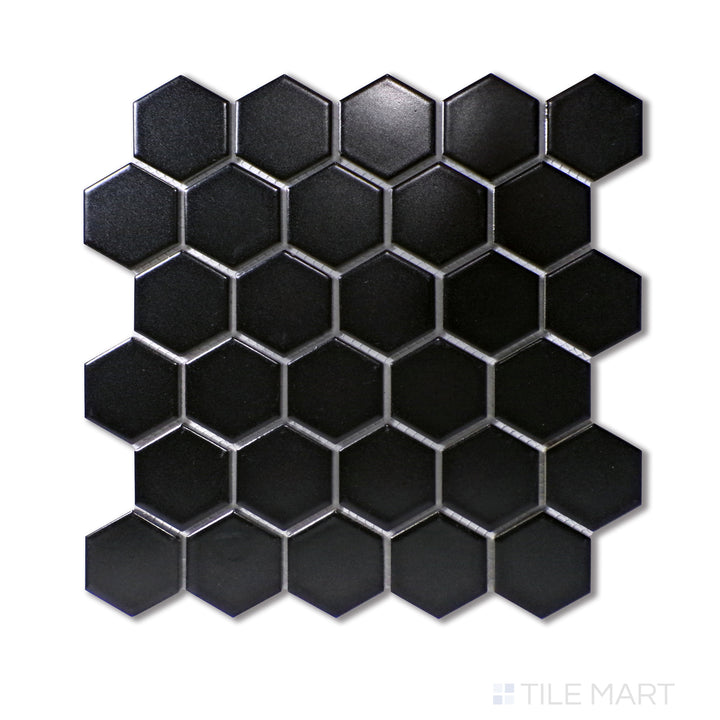 Angled shot of BLACK 2" HEXAGON GLOSSY PORCELAIN MOSAIC with a GLOSSY finish, offering a detailed look at the material's finish with a tilted viewpoint.