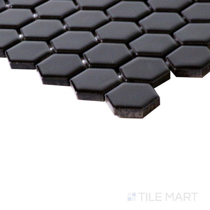 Corner shot of BLACK GLOSSY 1" HEX 6MM PORCELAIN MOSAIC with a GLOSSY finish, revealing the intricate edge detailing and thickness from a corner viewpoint.