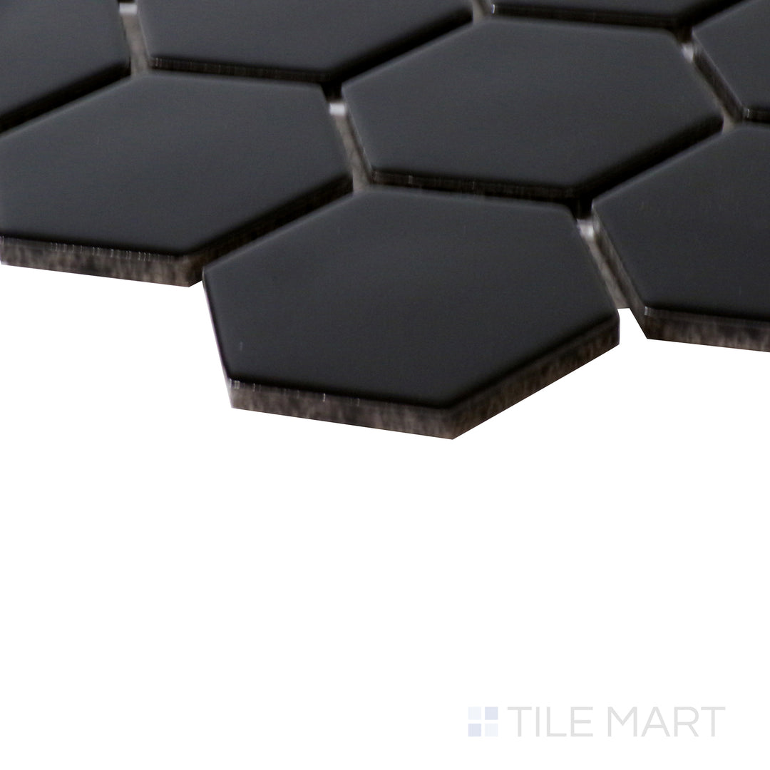 Corner shot of BLACK 2" HEXAGON MATTE PORCELAIN MOSAIC with a MATTE finish, highlighting the precision of the product's edge and the substantial thickness.
