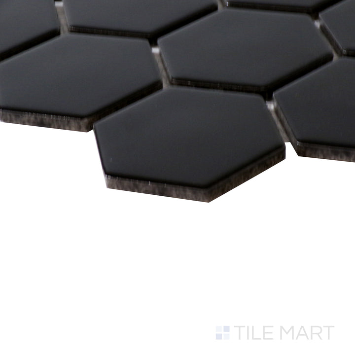 Corner shot of BLACK 2" HEXAGON MATTE PORCELAIN MOSAIC with a MATTE finish, highlighting the precision of the product's edge and the substantial thickness.