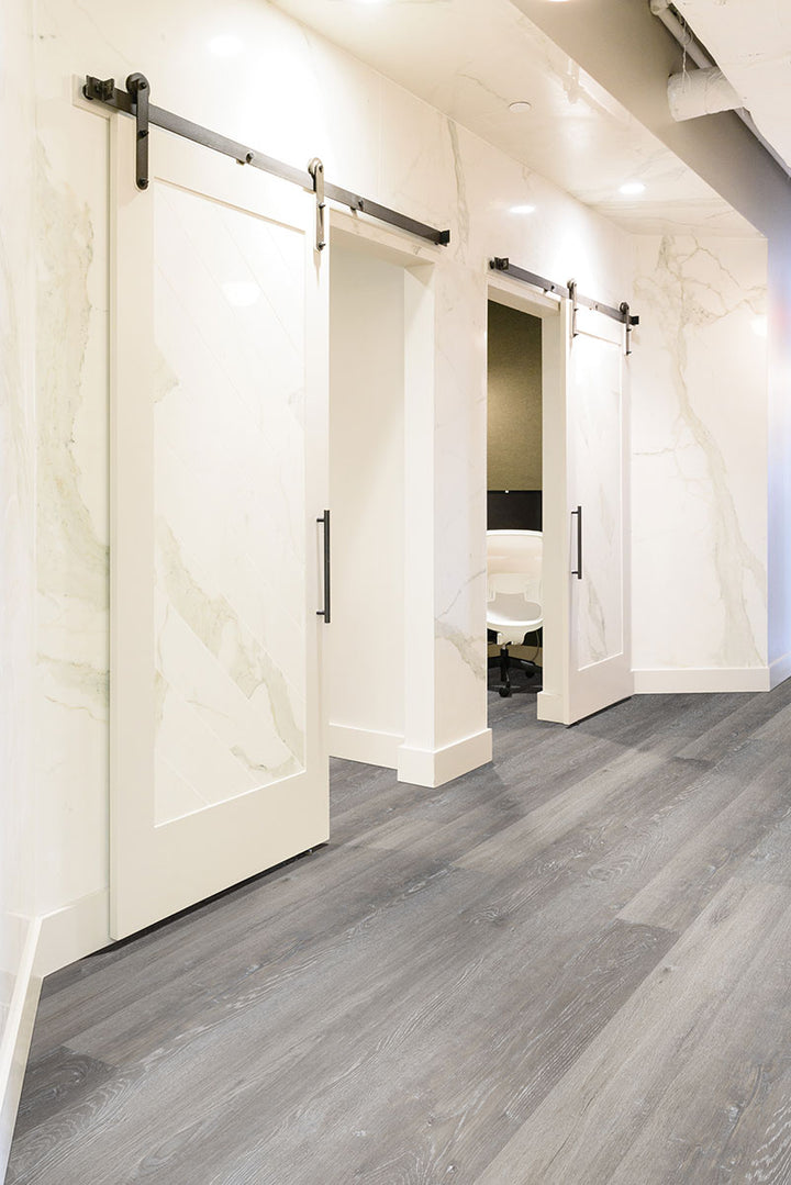 Open-concept room using Glenridge Elmwood Ash 6X48 Low Gloss Luxury Vinyl Plank flooring.