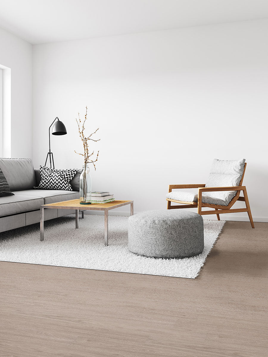 Bright, coastal-inspired room featuring Katavia Bleached Elm 6x48 low gloss luxury vinyl plank flooring with soft, sun-washed tones and subtle woodgrain details for an airy, modern feel.