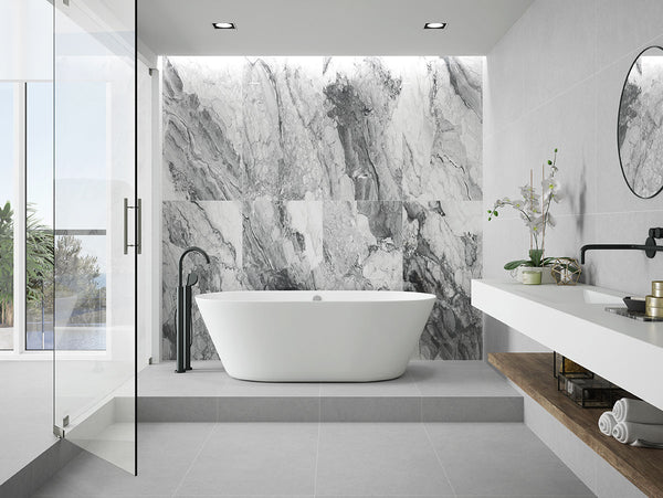 Subtle waves of gray add movement and depth to Kaya Onda Gray 24x48 matte porcelain tiles for a sleek, modern look.