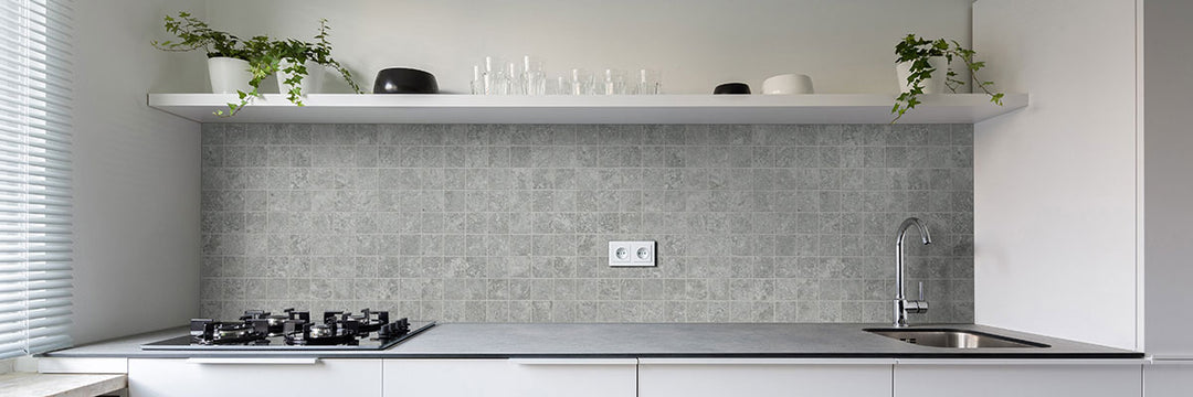 A small-format mosaic with soft silver tones and a matte finish adds intricate texture and depth with Legion Lunar Silver 2" square matte porcelain mosaic.