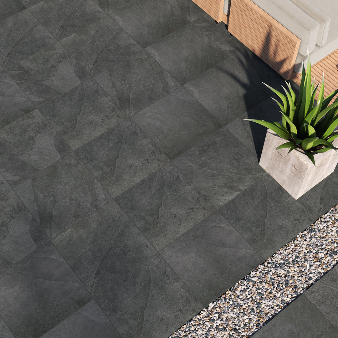 A bold black paver with a matte finish creates striking contrast and a sophisticated foundation, enhanced by Legion Black 24x24 paver matte porcelain.