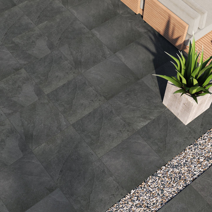 A bold black paver with a matte finish creates striking contrast and a sophisticated foundation, enhanced by Legion Black 24x24 paver matte porcelain.