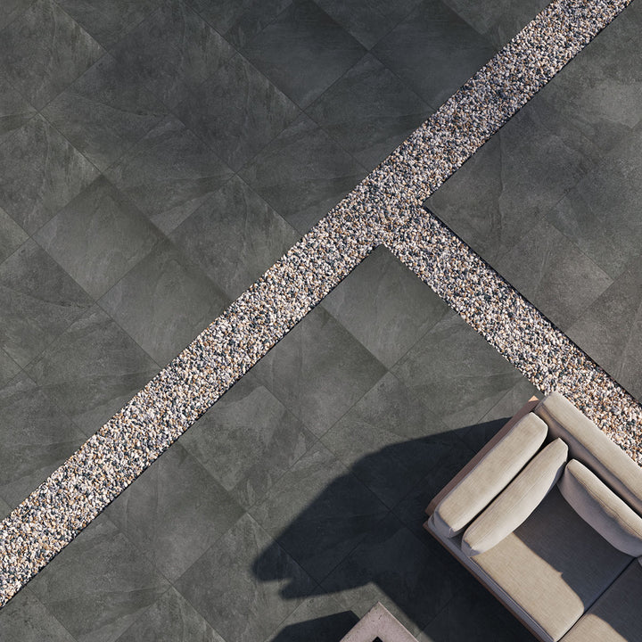 A bold black paver tile with a matte finish adds depth and contrast, bringing a striking aesthetic with Legion Black 24x24 paver matte porcelain.