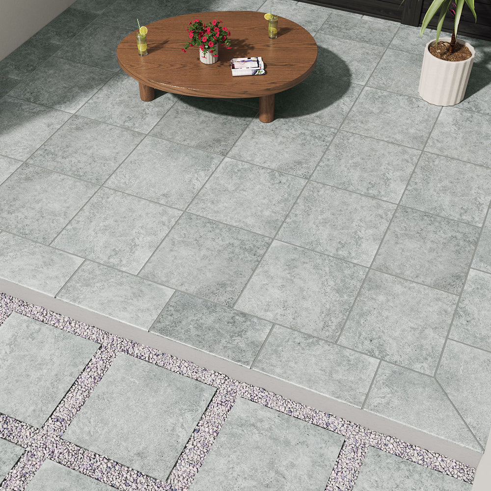 Displaying the refined texture of LEGIONS SILVER TRAV 24X24 PAVER PORCELAIN PAVER with a MATTE finish, creating a relaxed atmosphere with its serene presence.