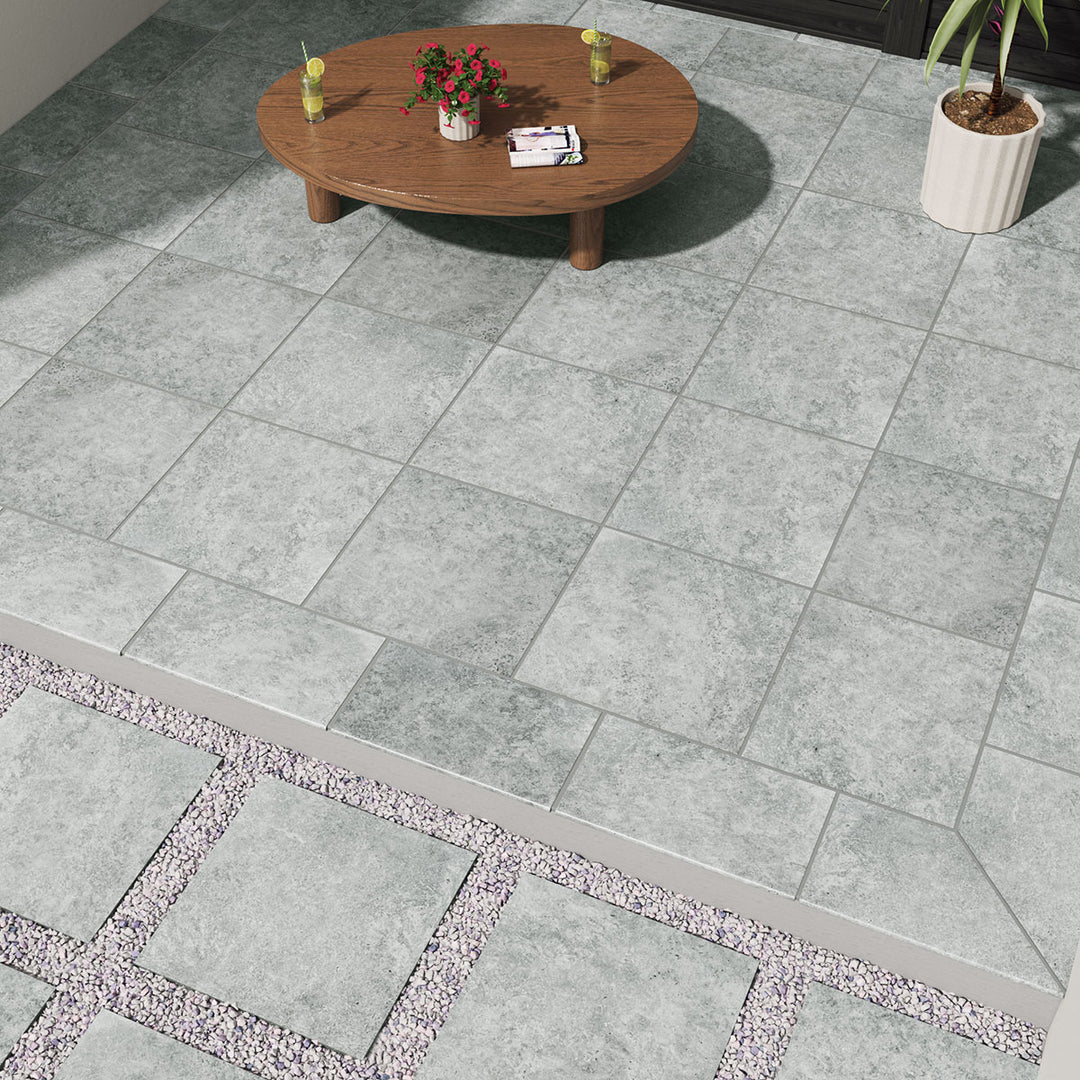 Displaying the refined texture of LEGIONS SILVER TRAV 24X24 PAVER PORCELAIN PAVER with a MATTE finish, creating a relaxed atmosphere with its serene presence.