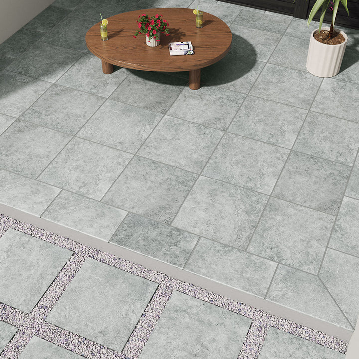 Displaying the refined texture of LEGIONS SILVER TRAV 24X24 PAVER PORCELAIN PAVER with a MATTE finish, creating a relaxed atmosphere with its serene presence.