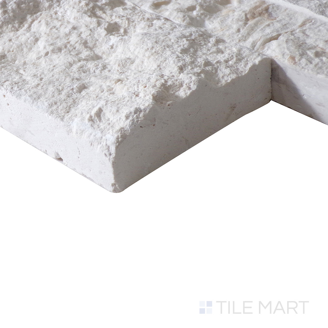 Corner shot of MAYRA WHITE LIMESTONE 6X24 PANEL LIMESTONE PANEL with a SPLITFACE finish, demonstrating the sturdy material and its subtle layering at the corner.