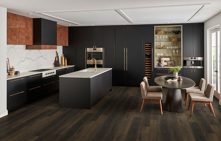 Cozy living area featuring Prescott Barrel 7x48 low gloss luxury vinyl plank flooring, with deep brown hues and rustic wood character for a warm, traditional style.