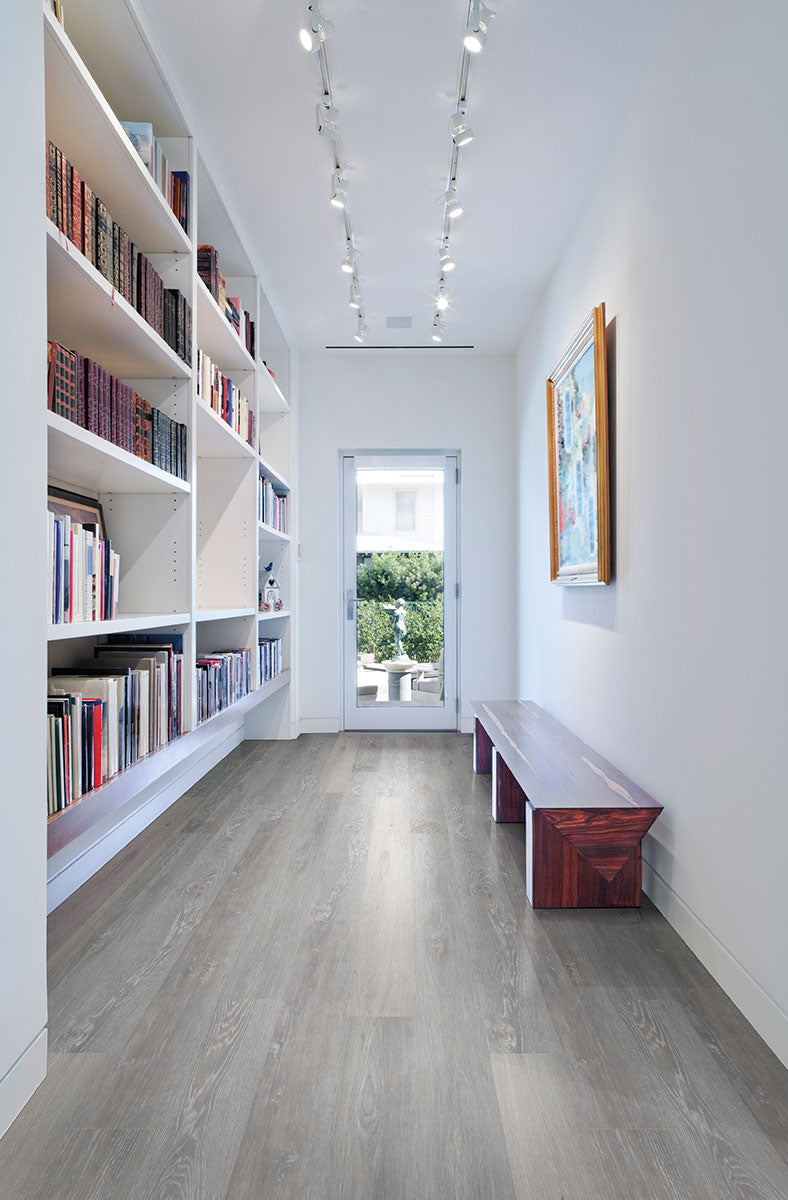 Minimalist room with Prescott Finely 7x48 low gloss vinyl plank flooring, featuring neutral undertones and smooth wood visuals for a clean, modern appeal.