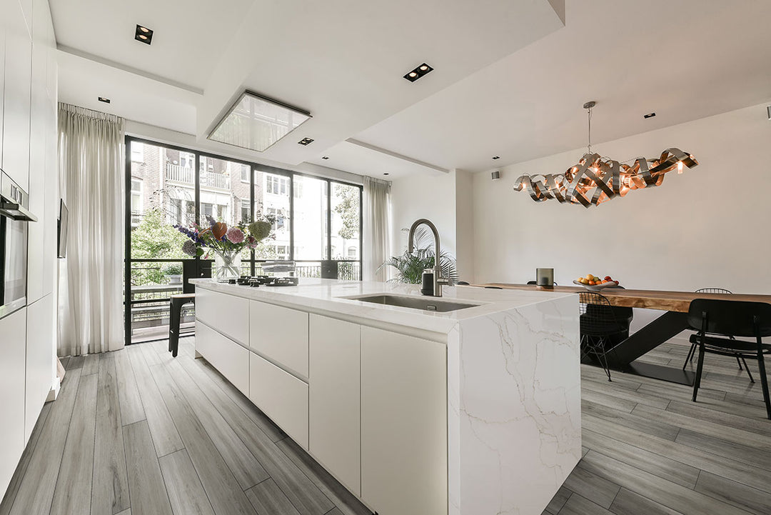 Contemporary room styled with Prescott XL Dunite Oak 9x60 low gloss vinyl flooring, showcasing soft taupe hues and extended wood visuals for a serene, organic feel.