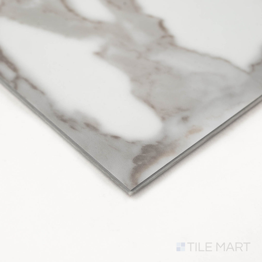 Trecento Calacatta Marbello 12X24 Low Gloss Luxury Vinyl Plank displayed at an angle to emphasize marble-like veining and edge profile.