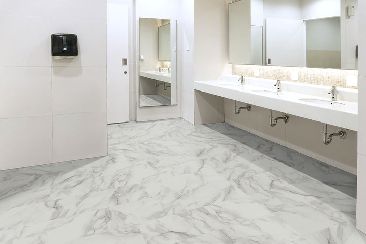 Sophisticated space showcasing Trecento Calacatta Venosa Gold 12x24 luxury vinyl plank flooring, with golden veining over a bright marble background for a refined, warm elegance.