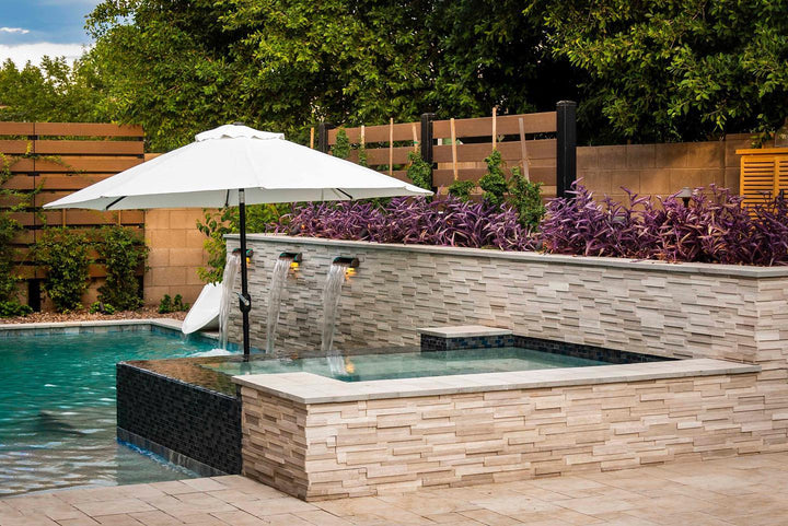 A white oak-inspired honed marble panel with 3D detailing enhances depth and dimension, creating a luxurious finish with Rockmount White Oak 6x24 3D stacked stone panel honed marble.
