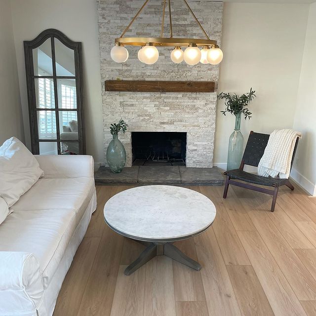 A textured splitface marble panel with warm white tones delivers a sophisticated and organic charm, beautifully styled with Rockmount White Oak 6x24 stacked stone panel splitface marble.