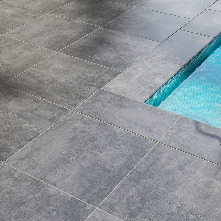 Rich charcoal hues with a subtle matte texture create a sleek and contemporary setting using Benton Antracite 24x24 paver matte porcelain.