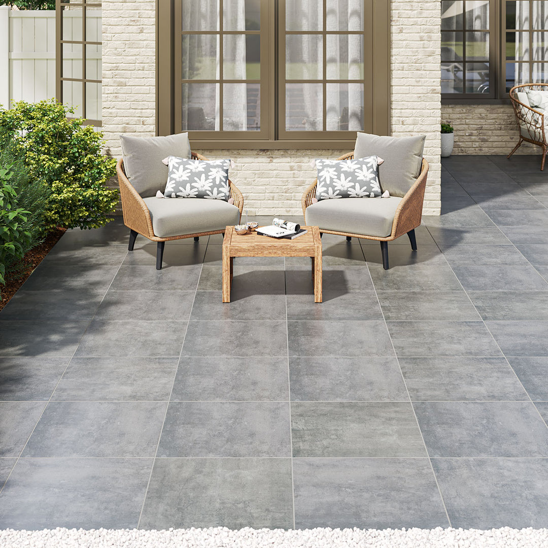 Modern outdoor patio featuring Benton Antracite 24x24 matte porcelain pavers, creating a sleek and sophisticated lifestyle setting. Durable and stylish for contemporary outdoor living.