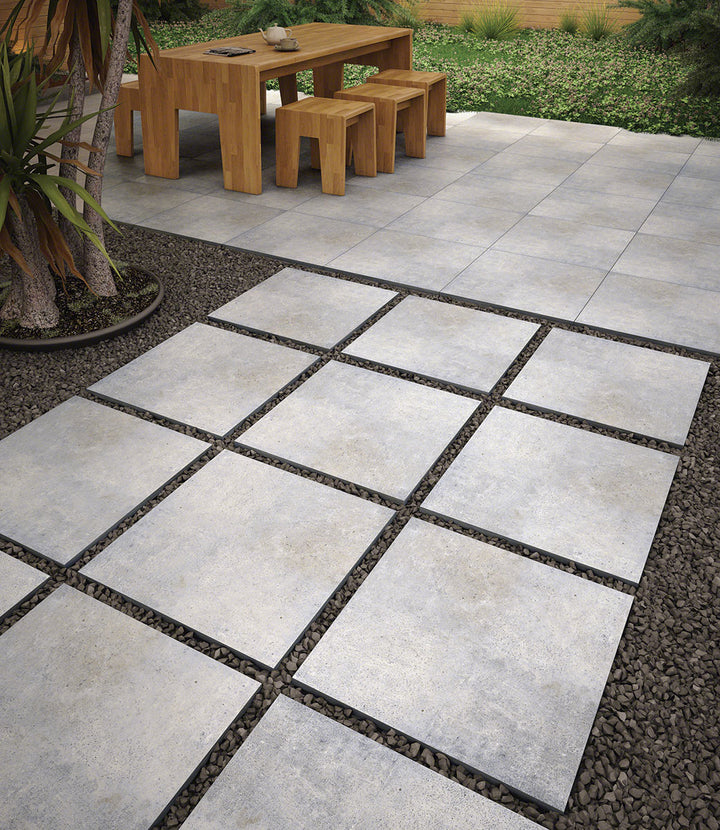 Displaying the refined texture of BETON GREY 24X24 PAVER PORCELAIN PAVER with a MATTE finish, blending effortlessly with the surrounding modern elements.