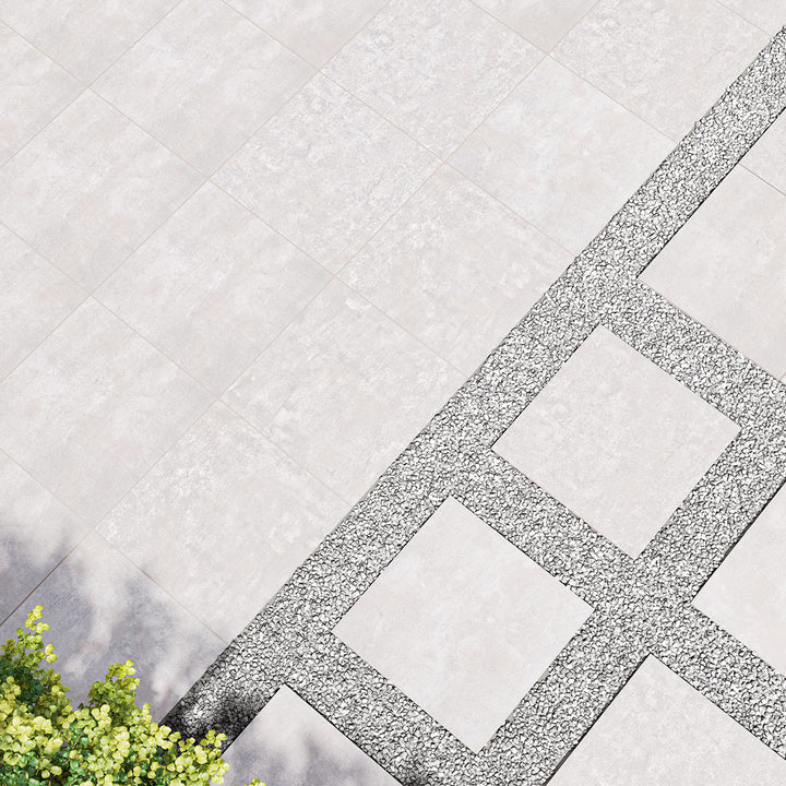 Stylish and contemporary room scene showcasing Benton Grey 24x24 matte porcelain pavers, blending seamlessly into modern outdoor and indoor spaces for a refined look.